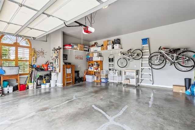 garage with baseboards and a garage door opener