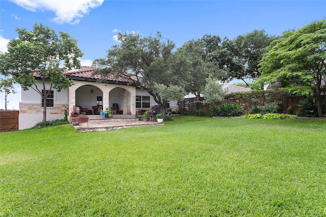 view of yard with fence and a patio