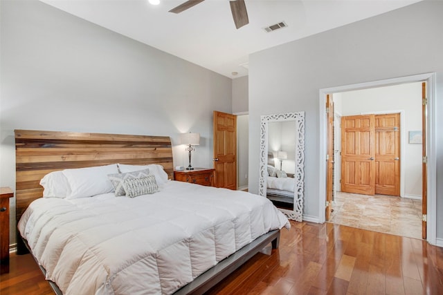 bedroom with light wood-type flooring, baseboards, visible vents, and ceiling fan