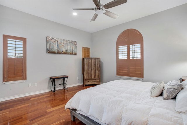 bedroom featuring ceiling fan, baseboards, wood finished floors, and recessed lighting