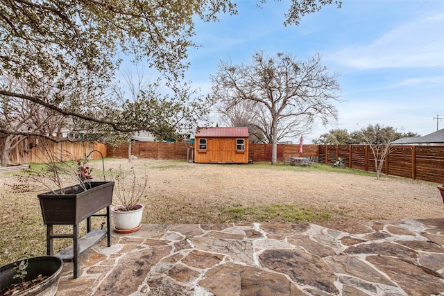 view of yard featuring an outbuilding, a shed, and a fenced backyard