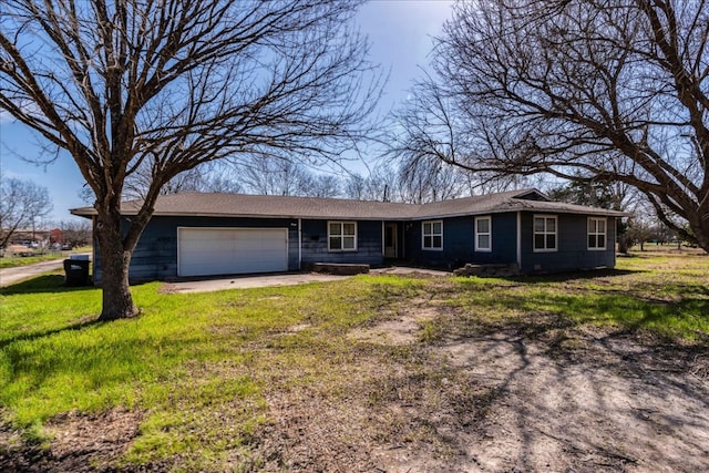 single story home with a garage, driveway, and a front lawn