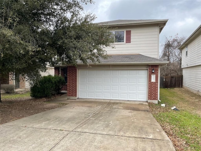 view of front facade featuring brick siding, concrete driveway, an attached garage, a front yard, and fence