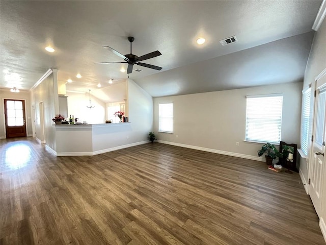 unfurnished living room featuring lofted ceiling, dark wood-type flooring, visible vents, and baseboards