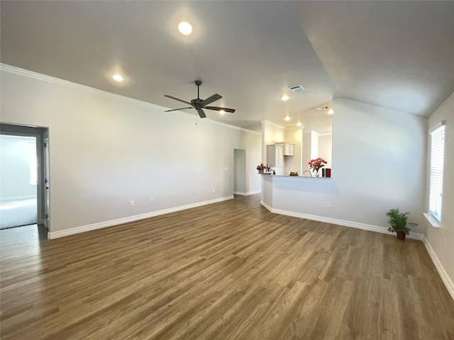 unfurnished living room featuring dark wood finished floors, lofted ceiling, ornamental molding, a ceiling fan, and baseboards