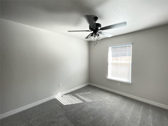 carpeted empty room featuring a ceiling fan, a textured ceiling, and baseboards