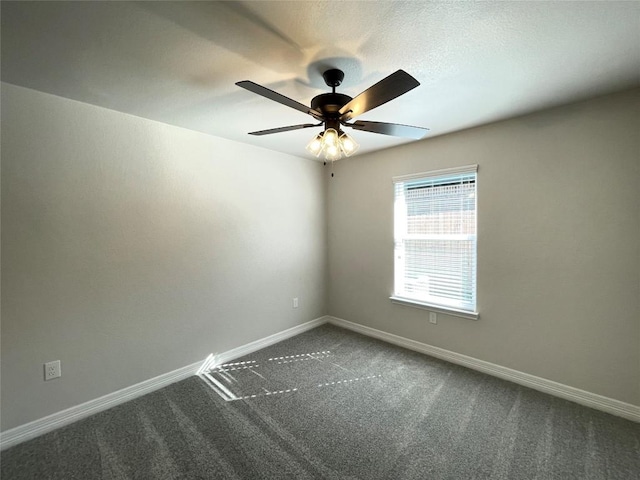 empty room with carpet floors, baseboards, and a ceiling fan