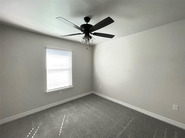 unfurnished room featuring carpet floors, ceiling fan, and baseboards