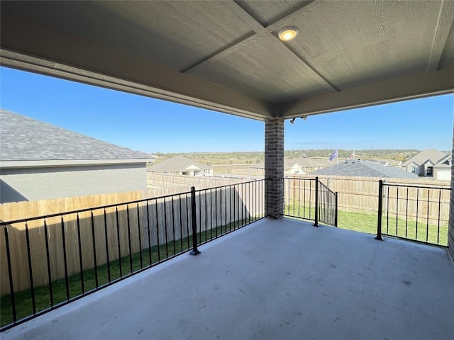 view of patio / terrace featuring a fenced backyard and a residential view