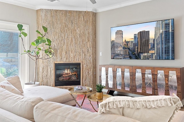 living area featuring a view of city, ornamental molding, a glass covered fireplace, and visible vents