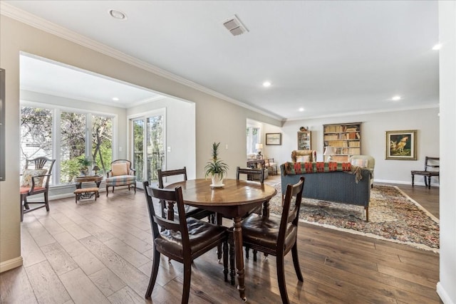 dining room featuring crown molding, visible vents, hardwood / wood-style floors, and recessed lighting