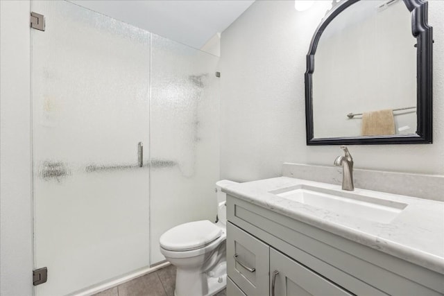 full bathroom featuring toilet, a shower stall, and vanity