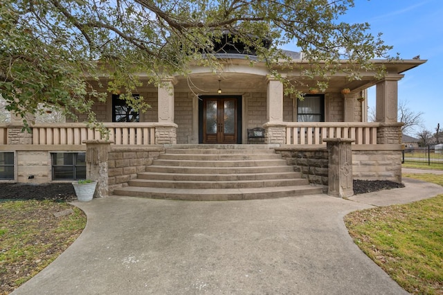 view of front of house featuring covered porch and french doors