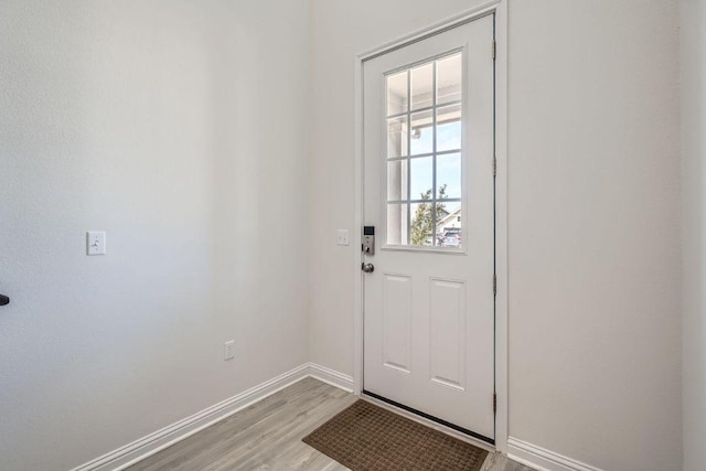 entryway with light wood finished floors and baseboards