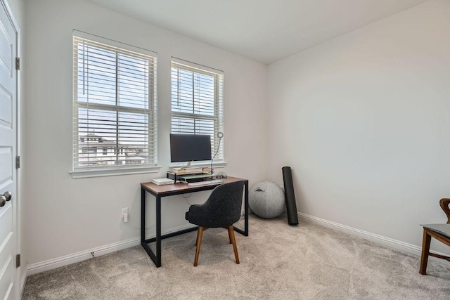 office space with light carpet and baseboards