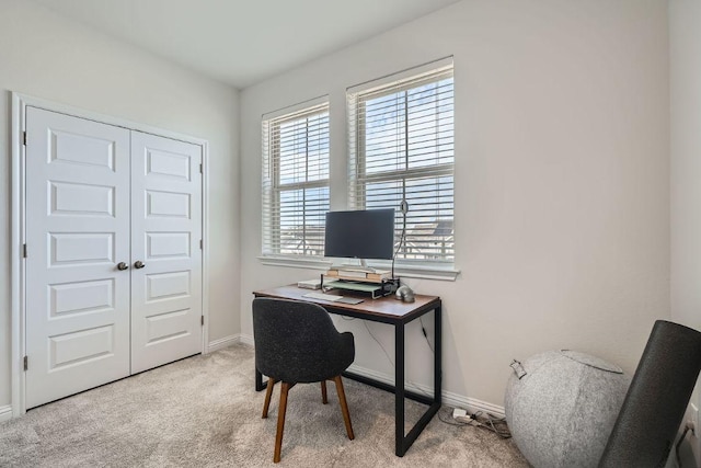 carpeted office featuring baseboards