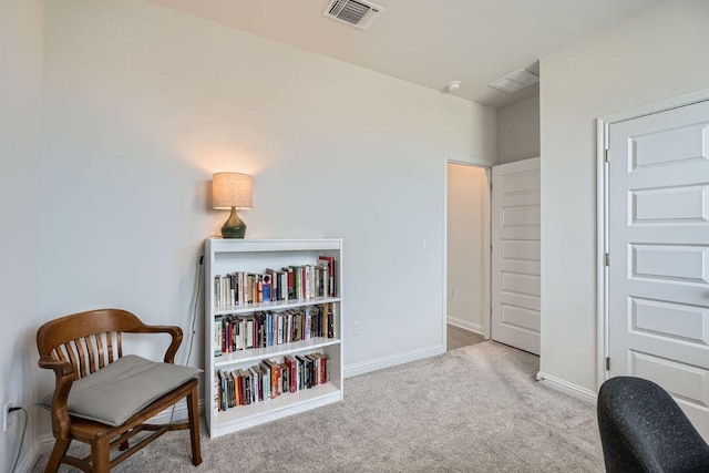 sitting room with carpet floors, visible vents, and baseboards