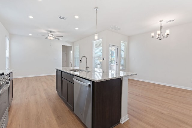 kitchen featuring stainless steel dishwasher, a sink, visible vents, and light wood-style floors