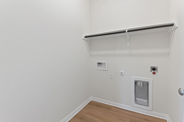 laundry area featuring laundry area, hookup for a gas dryer, wood finished floors, hookup for a washing machine, and electric dryer hookup