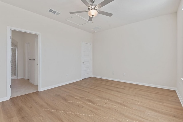 empty room with light wood-style flooring, visible vents, ceiling fan, and baseboards