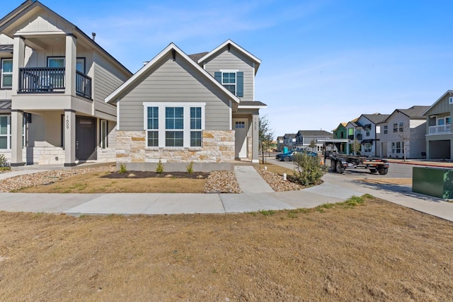 view of front facade featuring stone siding and a front yard