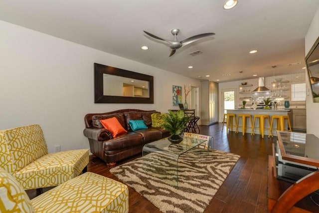 living area featuring dark wood-type flooring, recessed lighting, visible vents, and a ceiling fan