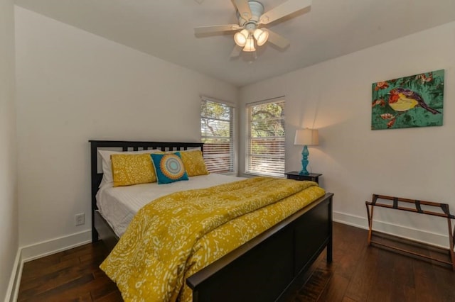 bedroom with hardwood / wood-style floors, a ceiling fan, and baseboards