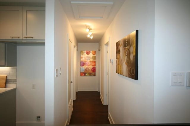 hall with attic access and baseboards