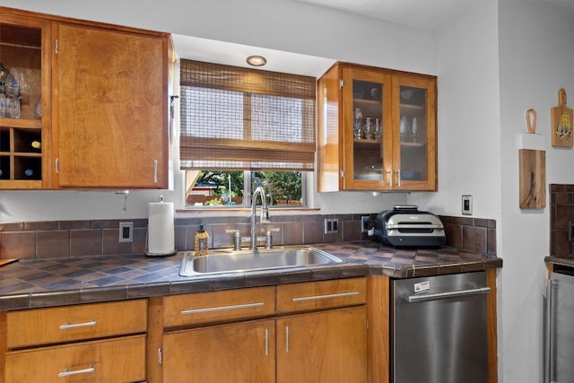 kitchen featuring brown cabinetry and a sink