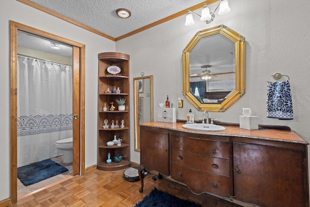 full bath featuring toilet, ornamental molding, a ceiling fan, a textured ceiling, and vanity