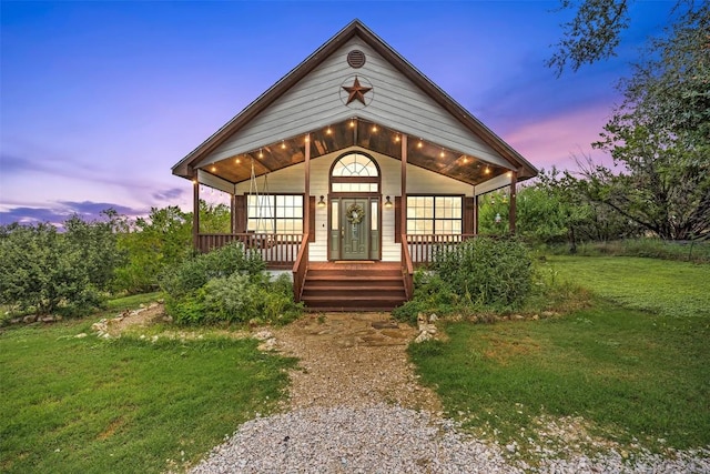 view of front of home featuring covered porch and a front yard