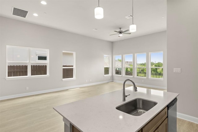 600 C-Bar Ranch Trl, Cedar Park, TX 78613 - kitchen featuring a sink, open floor plan, dishwasher, hanging light fixtures, and light wood-style floors