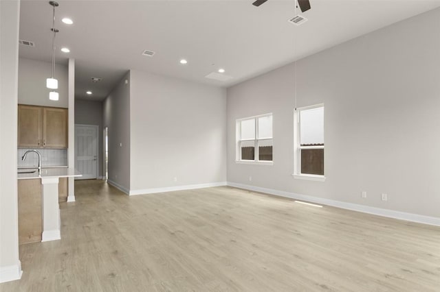 600 C-Bar Ranch Trl, Cedar Park, TX 78613 - unfurnished living room featuring a ceiling fan, light wood-style floors, recessed lighting, baseboards, and a sink