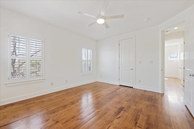 unfurnished bedroom featuring ceiling fan, baseboards, and wood finished floors