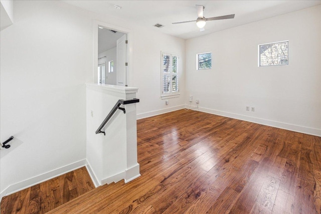 empty room with wood-type flooring and baseboards