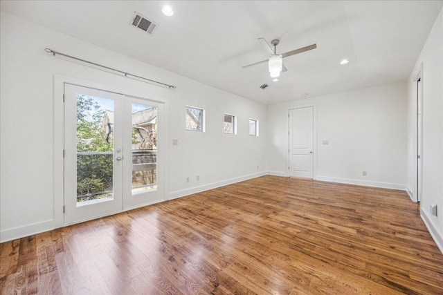 unfurnished room with baseboards, visible vents, ceiling fan, wood finished floors, and recessed lighting