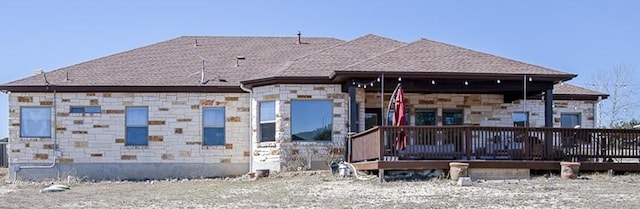 view of front of property featuring a deck and stone siding