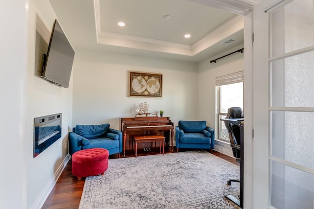 home office featuring a tray ceiling, visible vents, wood finished floors, and recessed lighting