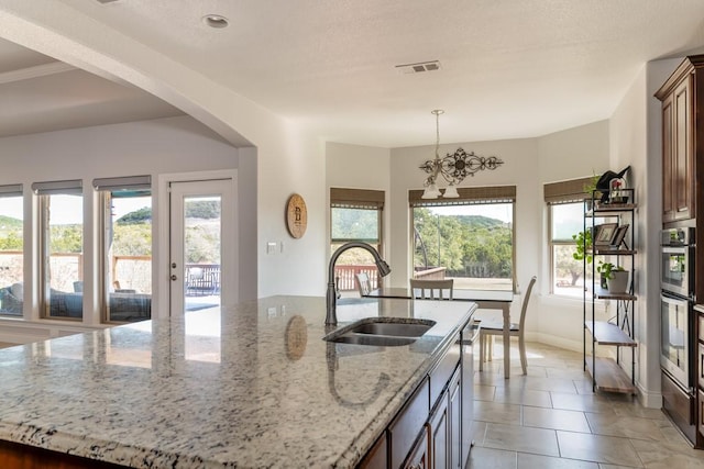 kitchen with appliances with stainless steel finishes, plenty of natural light, visible vents, and a sink