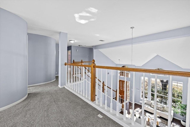 hall featuring carpet, vaulted ceiling with beams, visible vents, an upstairs landing, and baseboards