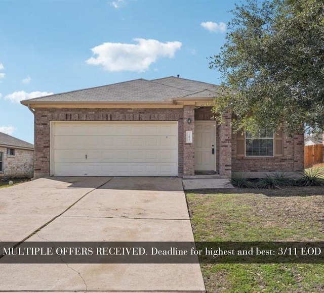 view of front of home with brick siding, driveway, and an attached garage