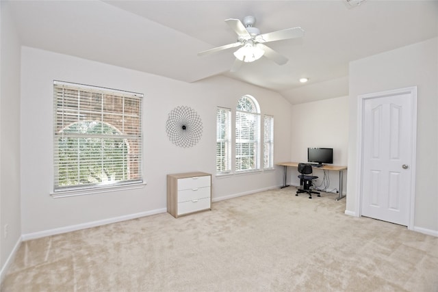 unfurnished office featuring carpet floors, ceiling fan, baseboards, and vaulted ceiling