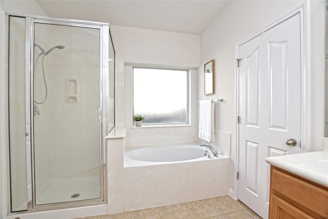 full bathroom featuring vanity, a shower stall, a bath, and tile patterned floors