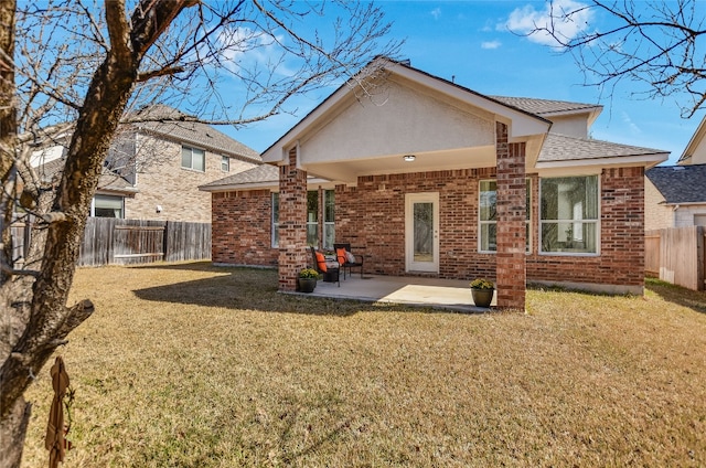 back of property with a patio area, a fenced backyard, a lawn, and brick siding