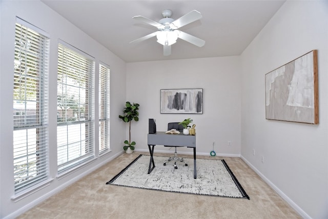 home office with carpet, baseboards, and a ceiling fan