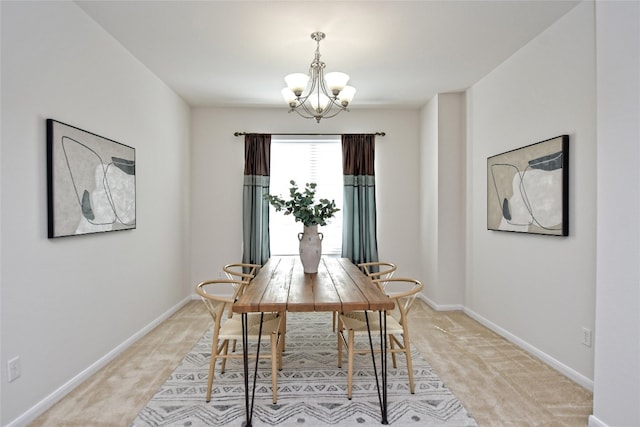 dining area with a chandelier, light carpet, and baseboards