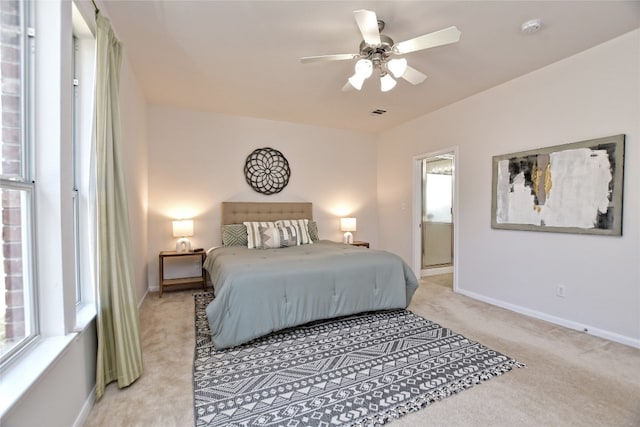 bedroom with light carpet, ceiling fan, and baseboards