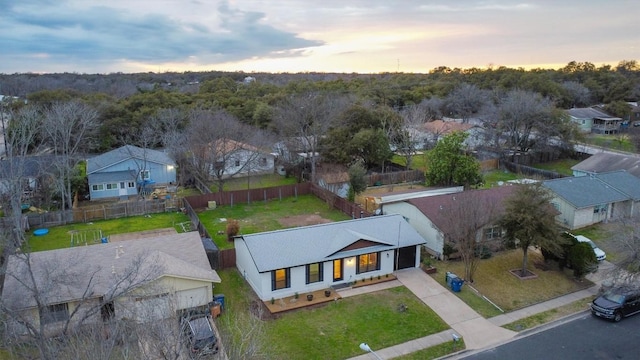 aerial view at dusk featuring a residential view