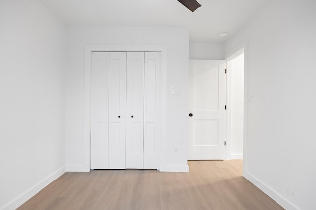 unfurnished bedroom featuring light wood-style floors and baseboards