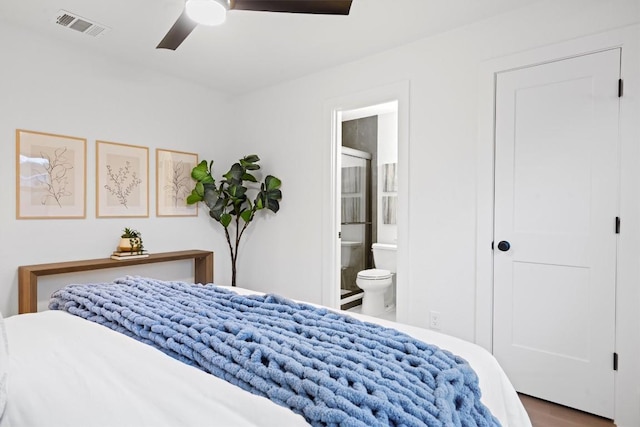 bedroom featuring ensuite bath, visible vents, and a ceiling fan